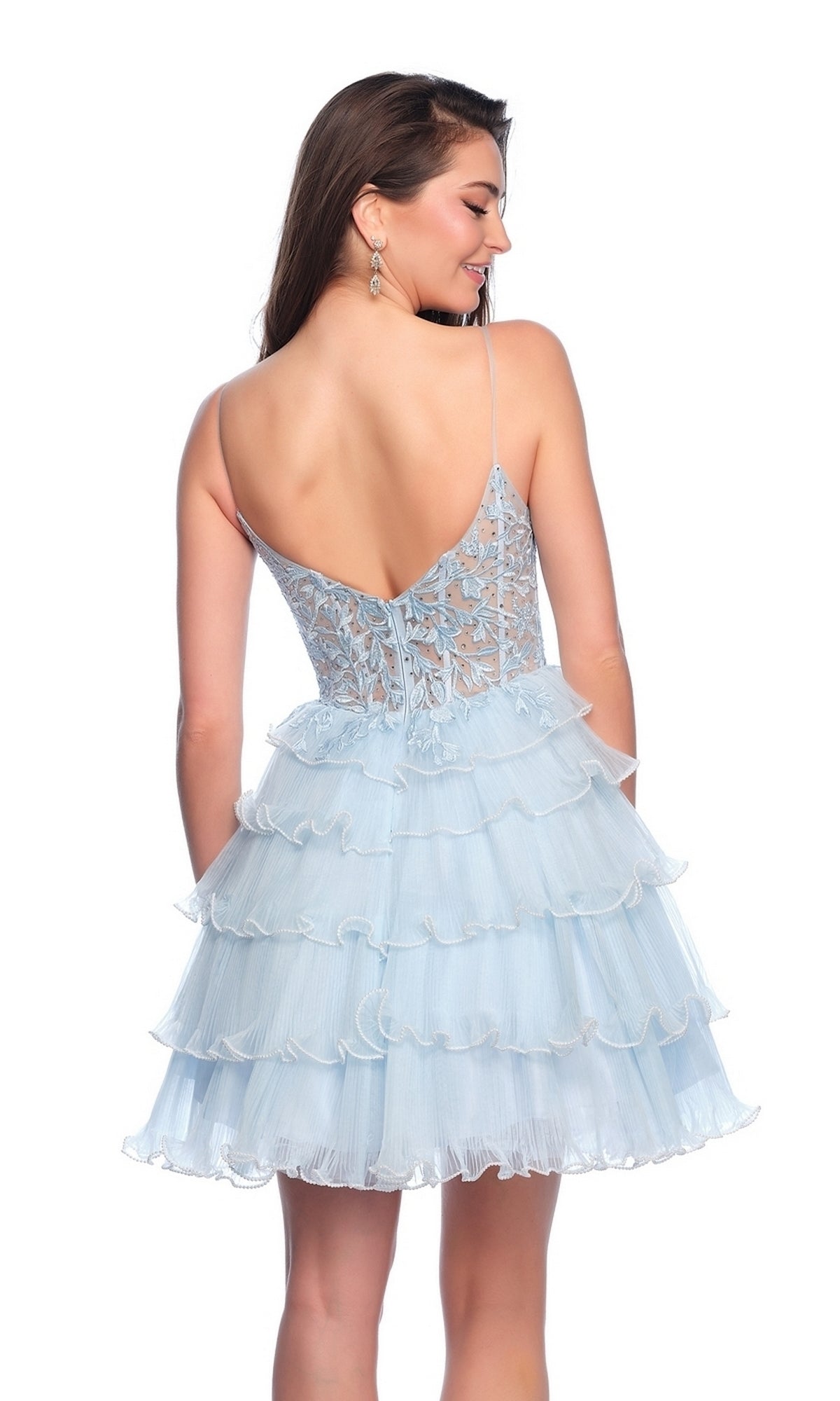 A woman stands smiling with her head turned, wearing the Dave and Johnny Short Blue A-Line Hoco Dress 11753 featuring a lace bodice and tiered ruffle skirt.